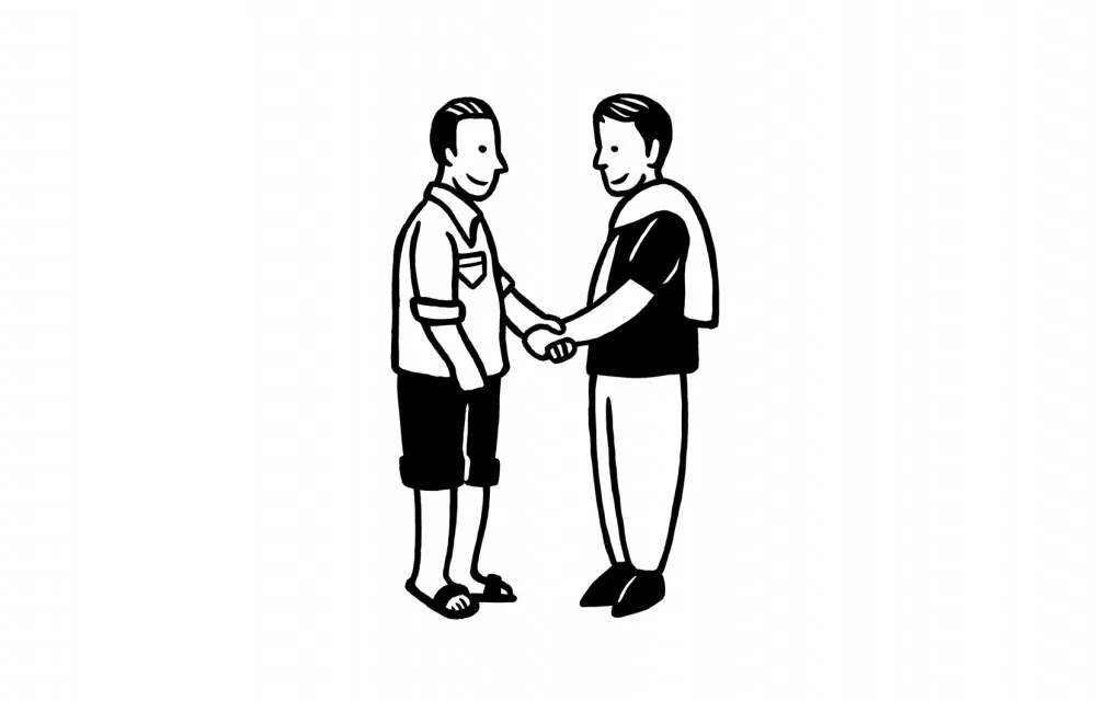 Two people shaking hands. The person on the left wears shorts and sandals, while the person on the right has a sweater over their shoulders.