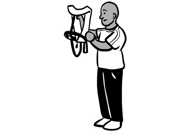 Illustration of a person holding a bicycle saddle, with both hands examining its features.